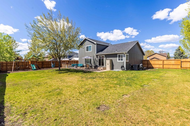 back of property with a playground, a patio area, board and batten siding, and a shingled roof
