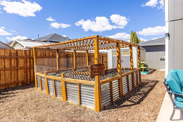 fenced backyard featuring a storage unit and an outbuilding