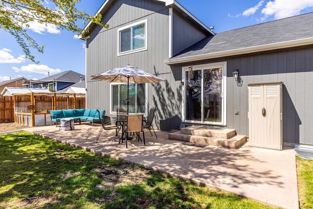 rear view of property with outdoor lounge area, a patio, and fence