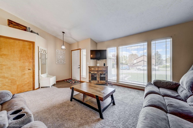 carpeted living room featuring lofted ceiling