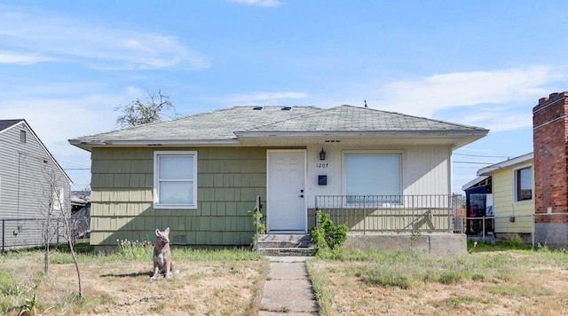 1207 E Garland Ave, Spokane, WA 99207 - bungalow-style home featuring roof with shingles and fence