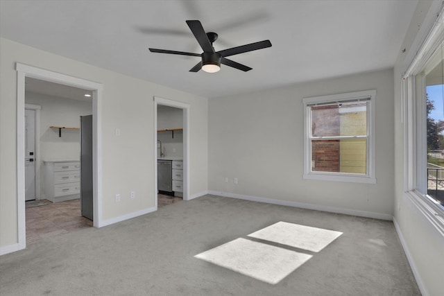 1207 E Garland Ave, Spokane, WA 99207 - unfurnished bedroom featuring carpet, a walk in closet, and baseboards