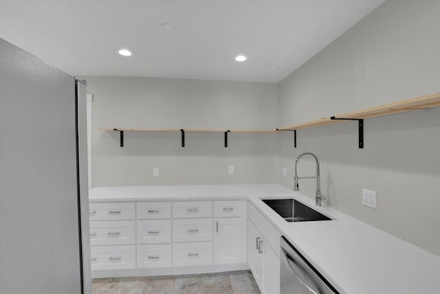 1207 E Garland Ave, Spokane, WA 99207 - kitchen with open shelves, a sink, white cabinetry, light countertops, and stainless steel dishwasher