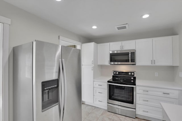 1207 E Garland Ave, Spokane, WA 99207 - kitchen featuring stainless steel appliances, light countertops, white cabinets, and recessed lighting