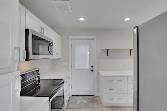 1207 E Garland Ave, Spokane, WA 99207 - kitchen with stainless steel appliances, light countertops, white cabinets, recessed lighting, and open shelves