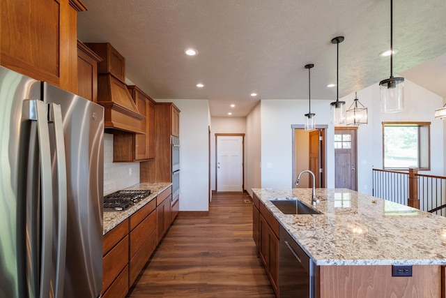 60874 Westview Dr, Nine Mile Falls, WA 99026 - kitchen featuring stainless steel appliances, a sink, custom exhaust hood, a center island with sink, and dark wood-style floors
