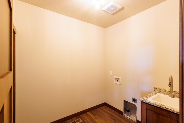 60874 Westview Dr, Nine Mile Falls, WA 99026 - washroom with hookup for an electric dryer, dark wood-type flooring, washer hookup, baseboards, and cabinet space
