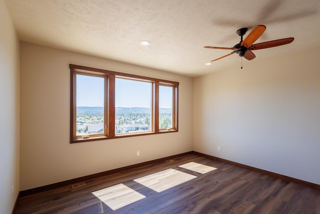 60874 Westview Dr, Nine Mile Falls, WA 99026 - empty room with dark wood-type flooring, recessed lighting, a ceiling fan, baseboards, and a textured ceiling