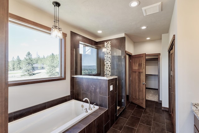 60874 Westview Dr, Nine Mile Falls, WA 99026 - full bath with a shower stall, a garden tub, recessed lighting, tile patterned flooring, and a spacious closet