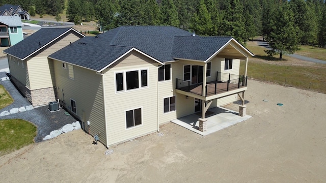 60874 Westview Dr, Nine Mile Falls, WA 99026 - back of property with a shingled roof, cooling unit, a balcony, and a patio area