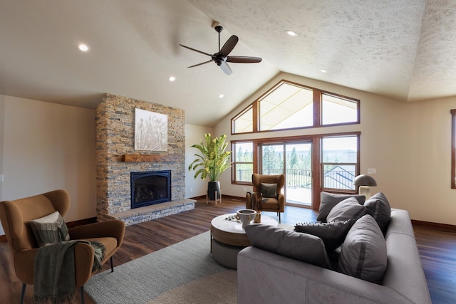 60874 Westview Dr, Nine Mile Falls, WA 99026 - living area with lofted ceiling, a ceiling fan, baseboards, dark wood-style flooring, and a stone fireplace