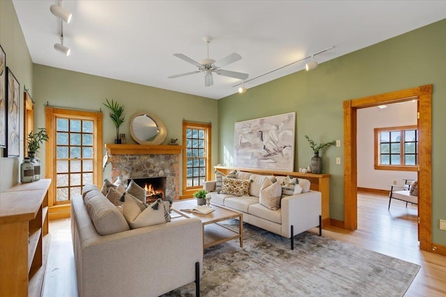 4408 E Spangle Creek Rd, Valleyford, WA 99036 - living room featuring rail lighting, ceiling fan, light wood-style flooring, and a fireplace
