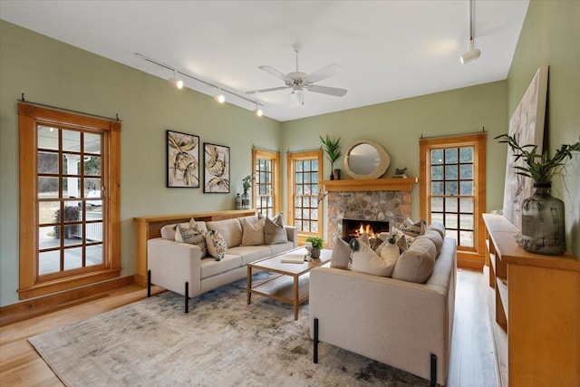 4408 E Spangle Creek Rd, Valleyford, WA 99036 - living area featuring track lighting, a ceiling fan, wood finished floors, and a fireplace