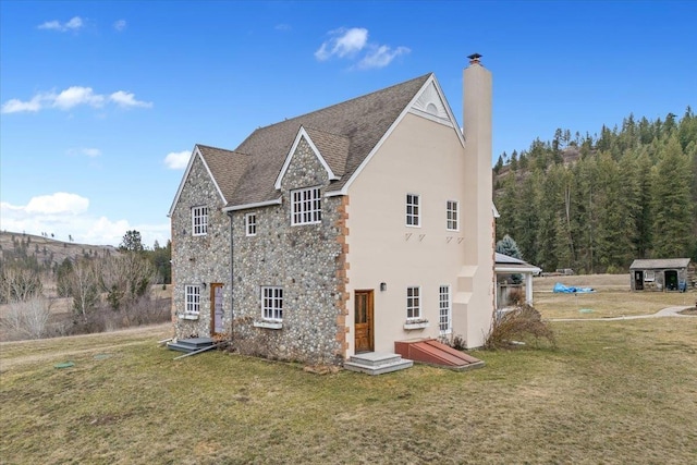 4408 E Spangle Creek Rd, Valleyford, WA 99036 - view of side of property featuring a chimney, a lawn, stone siding, and stucco siding