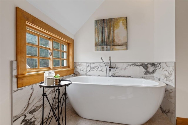 4408 E Spangle Creek Rd, Valleyford, WA 99036 - bathroom featuring tile walls, wainscoting, a freestanding tub, and lofted ceiling