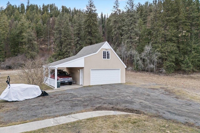 4408 E Spangle Creek Rd, Valleyford, WA 99036 - garage featuring a view of trees and a garage