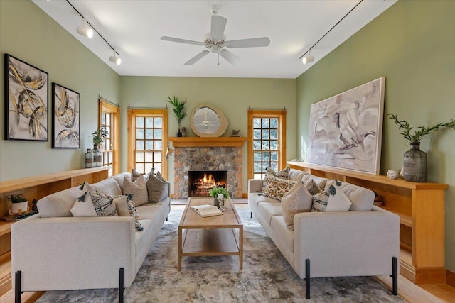 4408 E Spangle Creek Rd, Valleyford, WA 99036 - living area with rail lighting, plenty of natural light, a stone fireplace, and ceiling fan