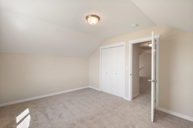 bonus room with lofted ceiling, carpet flooring, and baseboards