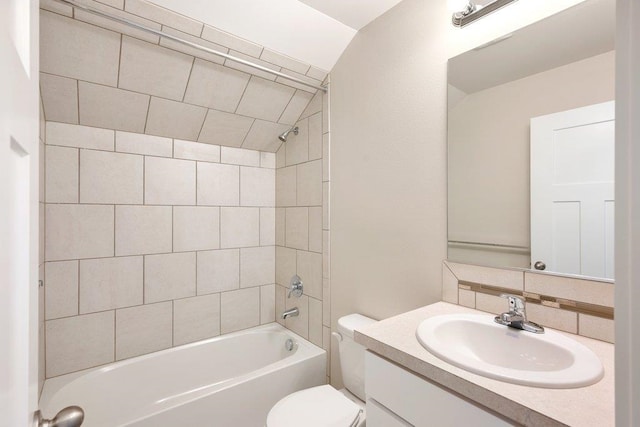 bathroom featuring toilet, vanity, washtub / shower combination, and decorative backsplash