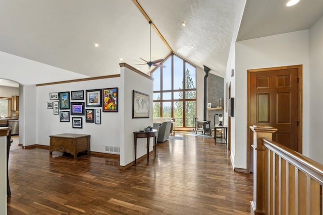 12715 E Deer Creek Rd, Chattaroy, WA 99003 - corridor featuring arched walkways, vaulted ceiling, dark wood-style floors, and baseboards