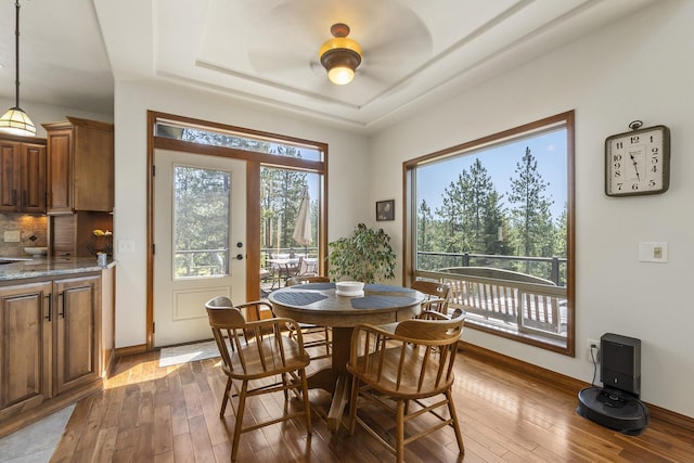 12715 E Deer Creek Rd, Chattaroy, WA 99003 - dining room with dark wood-style floors, a raised ceiling, and baseboards