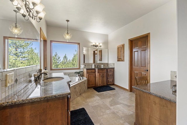12715 E Deer Creek Rd, Chattaroy, WA 99003 - full bathroom featuring vanity, tiled bath, a chandelier, and baseboards
