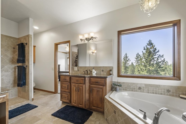 12715 E Deer Creek Rd, Chattaroy, WA 99003 - full bathroom featuring a chandelier, a bath, vanity, toilet, and a tile shower