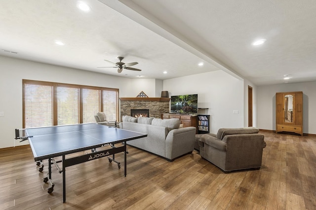 12715 E Deer Creek Rd, Chattaroy, WA 99003 - recreation room with wood-type flooring, a ceiling fan, recessed lighting, and a fireplace