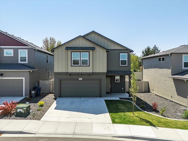 view of front of home with a garage, board and batten siding, concrete driveway, and fence