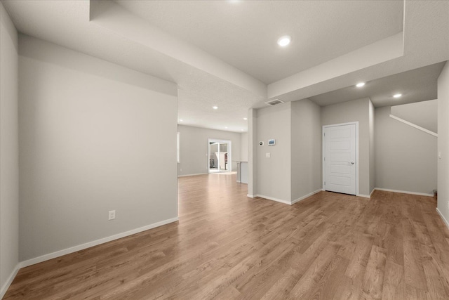 below grade area featuring recessed lighting, light wood finished floors, and baseboards