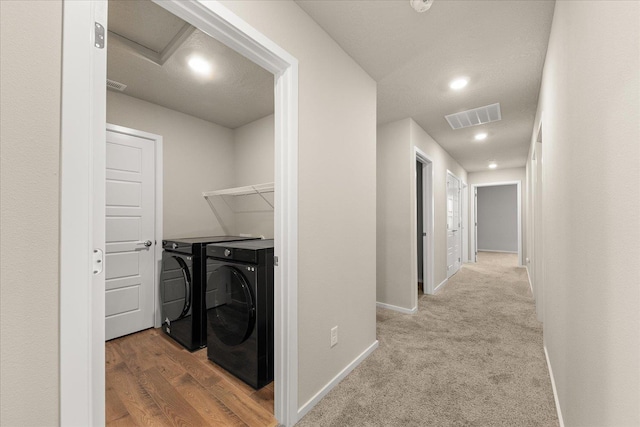 washroom with washer and dryer, baseboards, and recessed lighting