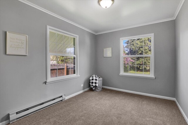 empty room featuring a baseboard heating unit, crown molding, carpet, and baseboards