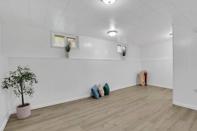washroom with wood finished floors and baseboards