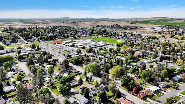 aerial view of property's location with a mountainous background and nearby suburban area