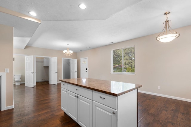 kitchen featuring baseboards, dark wood-type flooring, a chandelier, white cabinets, and recessed lighting