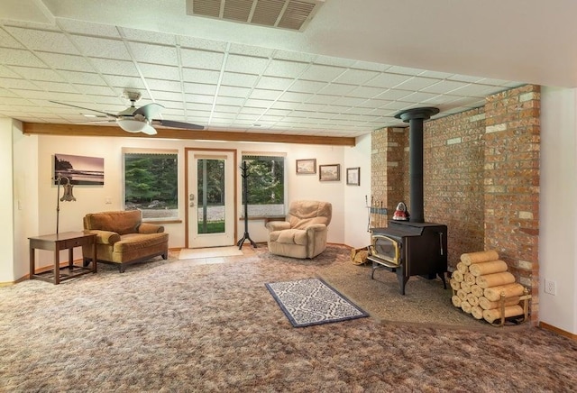 4414 Garden Spot Rd, Clayton, WA 99110 - living room with a wood stove, ceiling fan, and carpet flooring