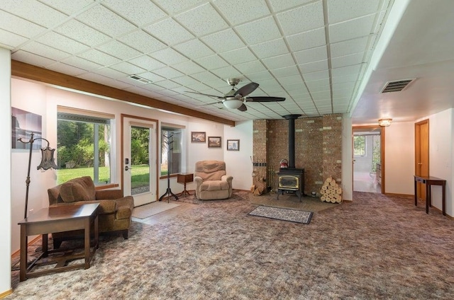 4414 Garden Spot Rd, Clayton, WA 99110 - living room featuring a wood stove, healthy amount of natural light, a ceiling fan, and carpet