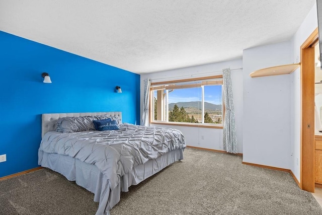 5612 N Vista Grande Dr, Otis Orchards, WA 99027 - bedroom with carpet, a textured ceiling, baseboards, and a mountain view