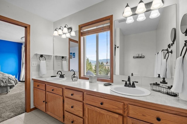 5612 N Vista Grande Dr, Otis Orchards, WA 99027 - ensuite bathroom featuring healthy amount of natural light, double vanity, a mountain view, and tile patterned flooring