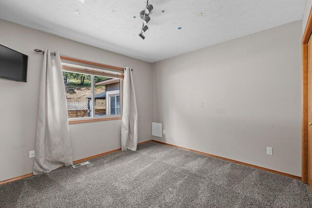 5612 N Vista Grande Dr, Otis Orchards, WA 99027 - spare room with carpet flooring, baseboards, and a textured ceiling