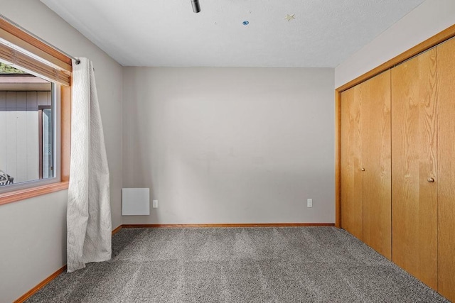 5612 N Vista Grande Dr, Otis Orchards, WA 99027 - unfurnished bedroom with carpet flooring, a closet, and baseboards