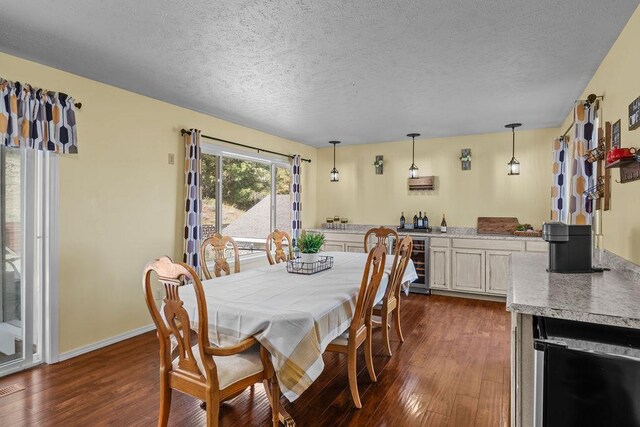 5612 N Vista Grande Dr, Otis Orchards, WA 99027 - dining room featuring beverage cooler, dark wood-style flooring, a textured ceiling, and baseboards