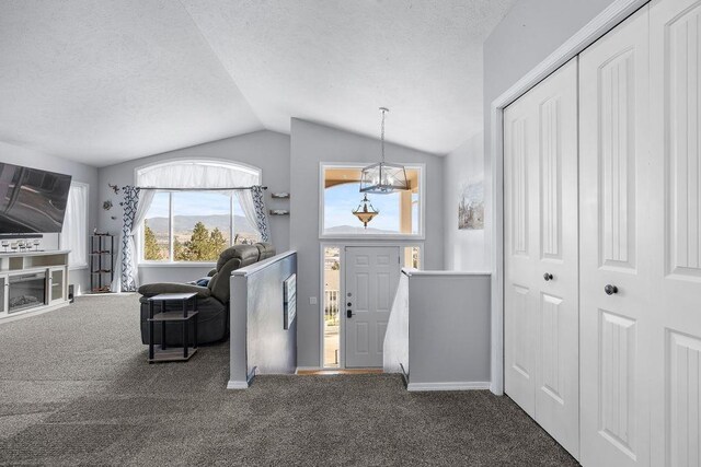 5612 N Vista Grande Dr, Otis Orchards, WA 99027 - entryway featuring carpet flooring, vaulted ceiling, a textured ceiling, and baseboards
