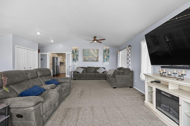 5612 N Vista Grande Dr, Otis Orchards, WA 99027 - carpeted living room with lofted ceiling, a ceiling fan, and baseboards