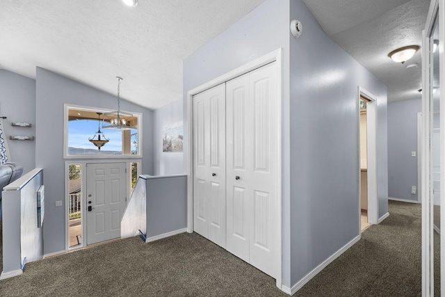 5612 N Vista Grande Dr, Otis Orchards, WA 99027 - foyer with a textured ceiling, carpet, vaulted ceiling, baseboards, and a chandelier