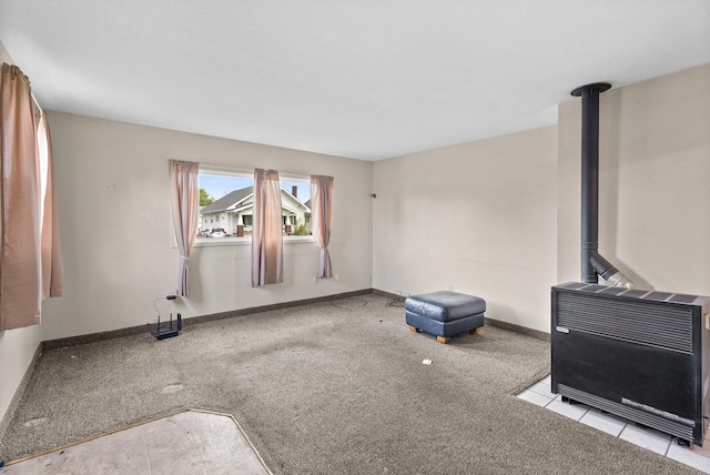 2124 N Dakota St, Spokane, WA 99207 - unfurnished living room featuring a wood stove, baseboards, heating unit, and carpet flooring