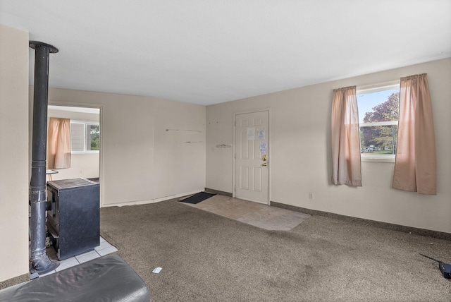 2124 N Dakota St, Spokane, WA 99207 - carpeted entrance foyer with a wood stove, healthy amount of natural light, and baseboards
