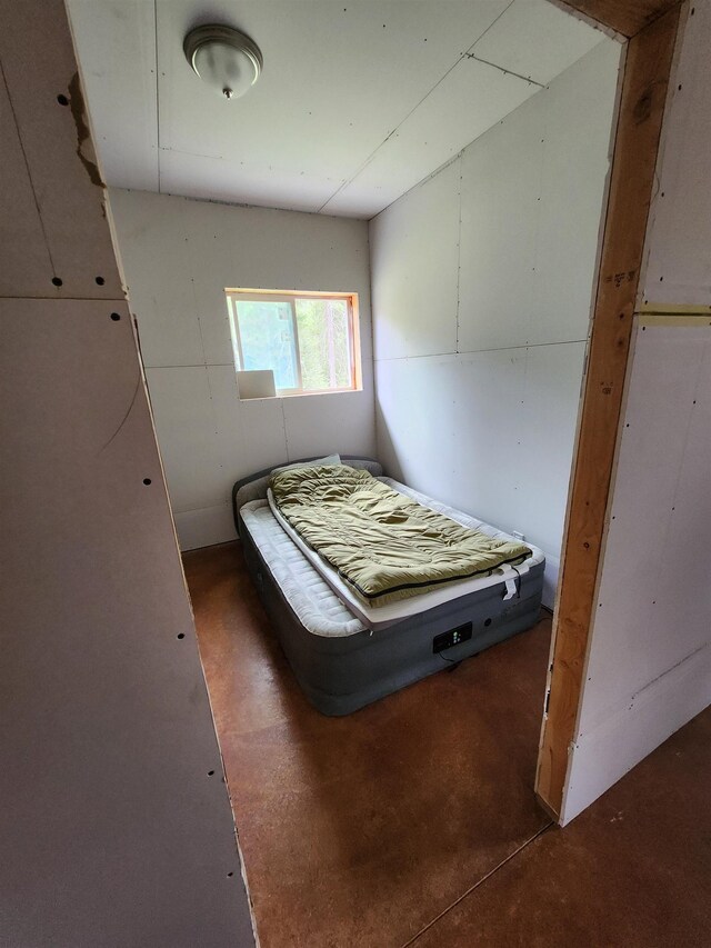 bedroom featuring concrete floors