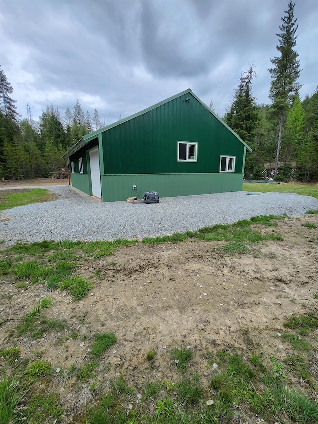 view of outdoor structure with a forest view
