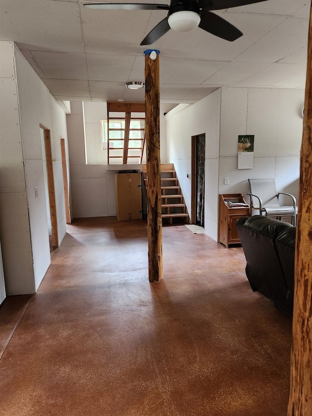 basement with stairway and ceiling fan